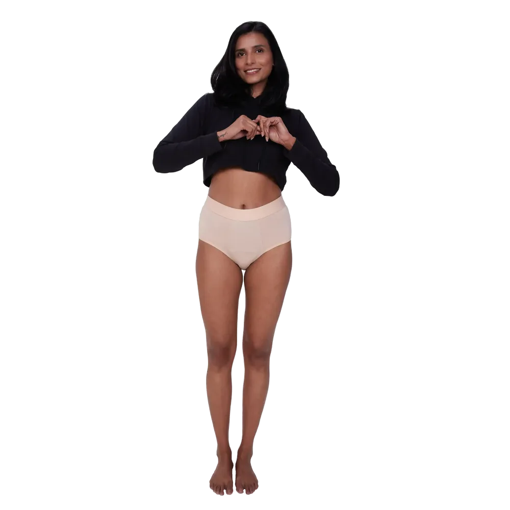 front view of a woman wearing a nude coloured high-waisted bamboo period underwear showing maximum comfort