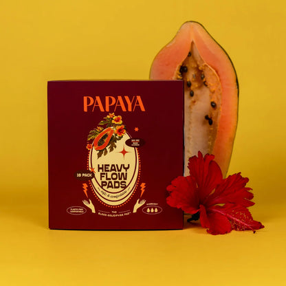 Box of Papaya Heavy Flow Pads with a papaya and red flower on a yellow background