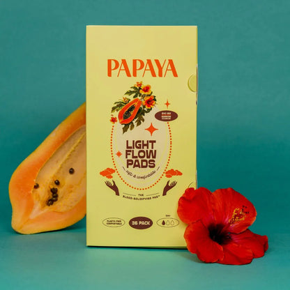 Box of Papaya Light Flow Pads with a papaya and red flower on a teal background