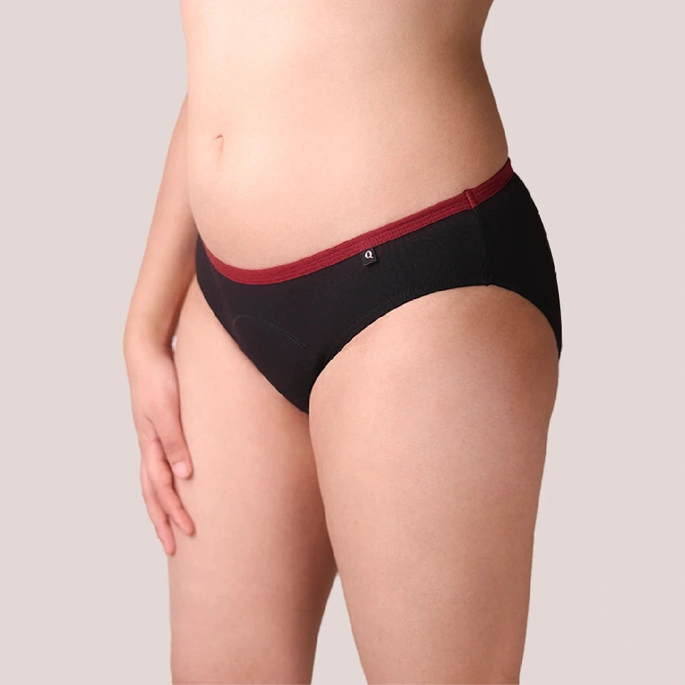 Black underwear with red trim on a neutral background