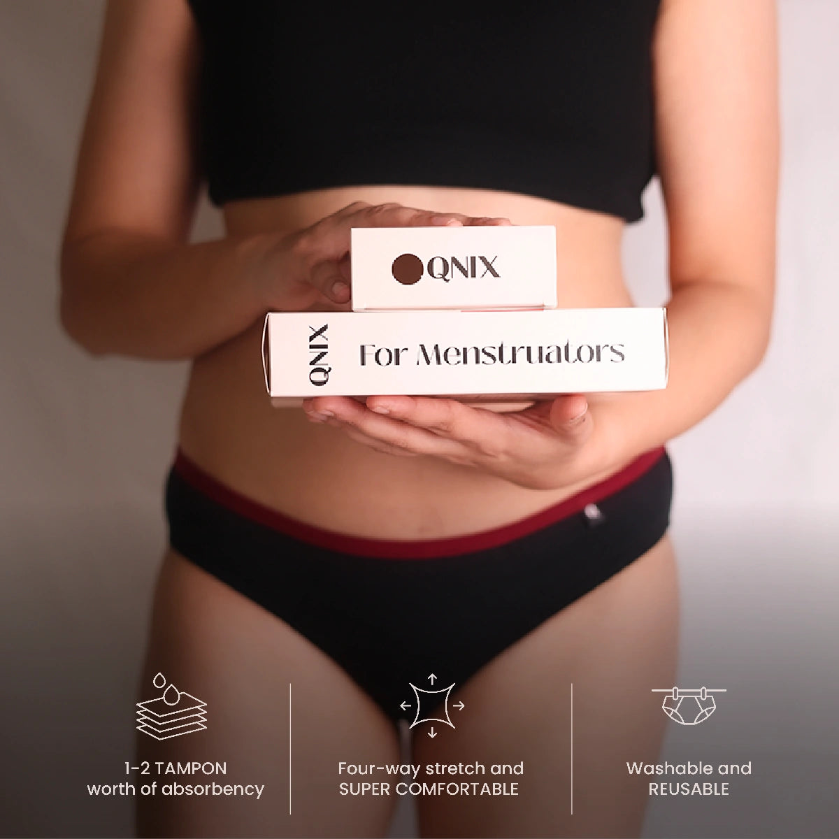 Person holding QNIX products with a focus on comfort and absorbency features.
