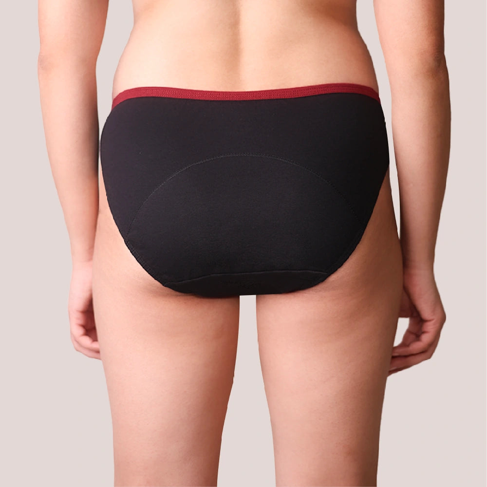 Black underwear with red waistband on a neutral background