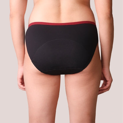 Black underwear with red waistband on a neutral background