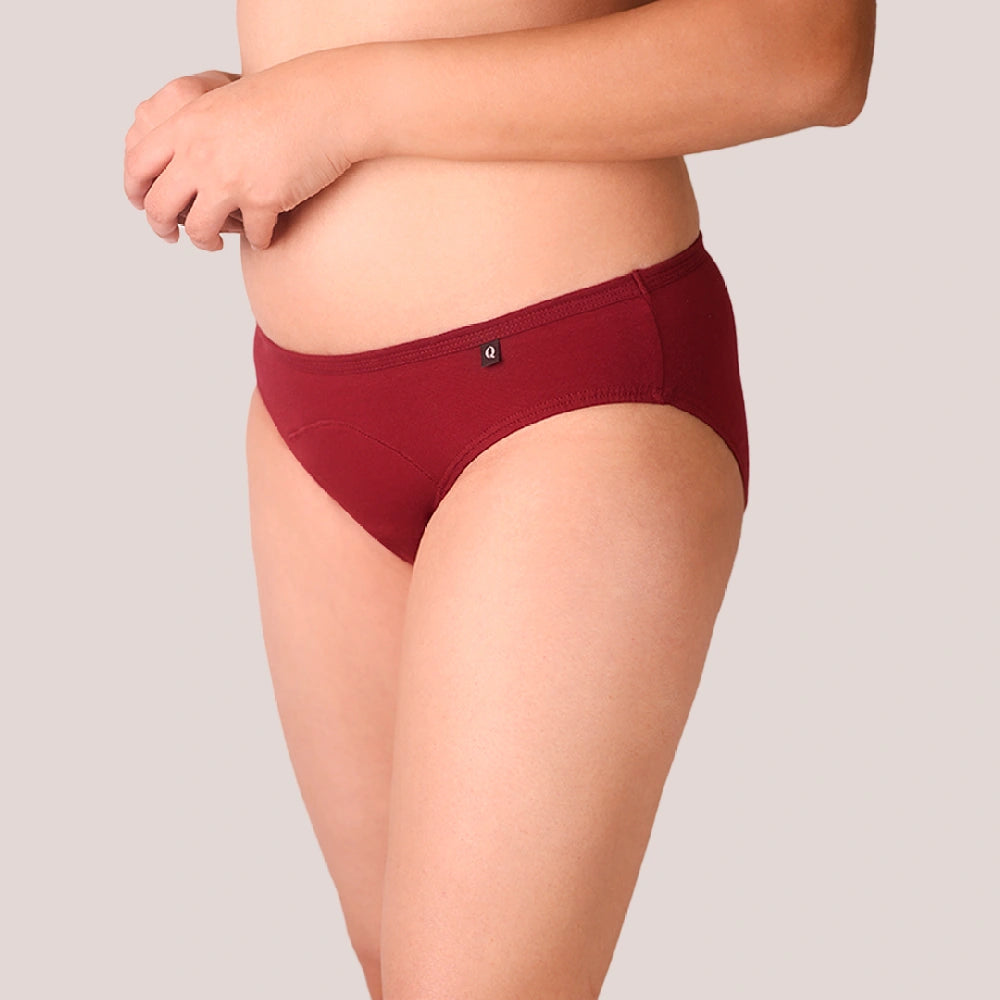 Red underwear worn by a person on a plain background