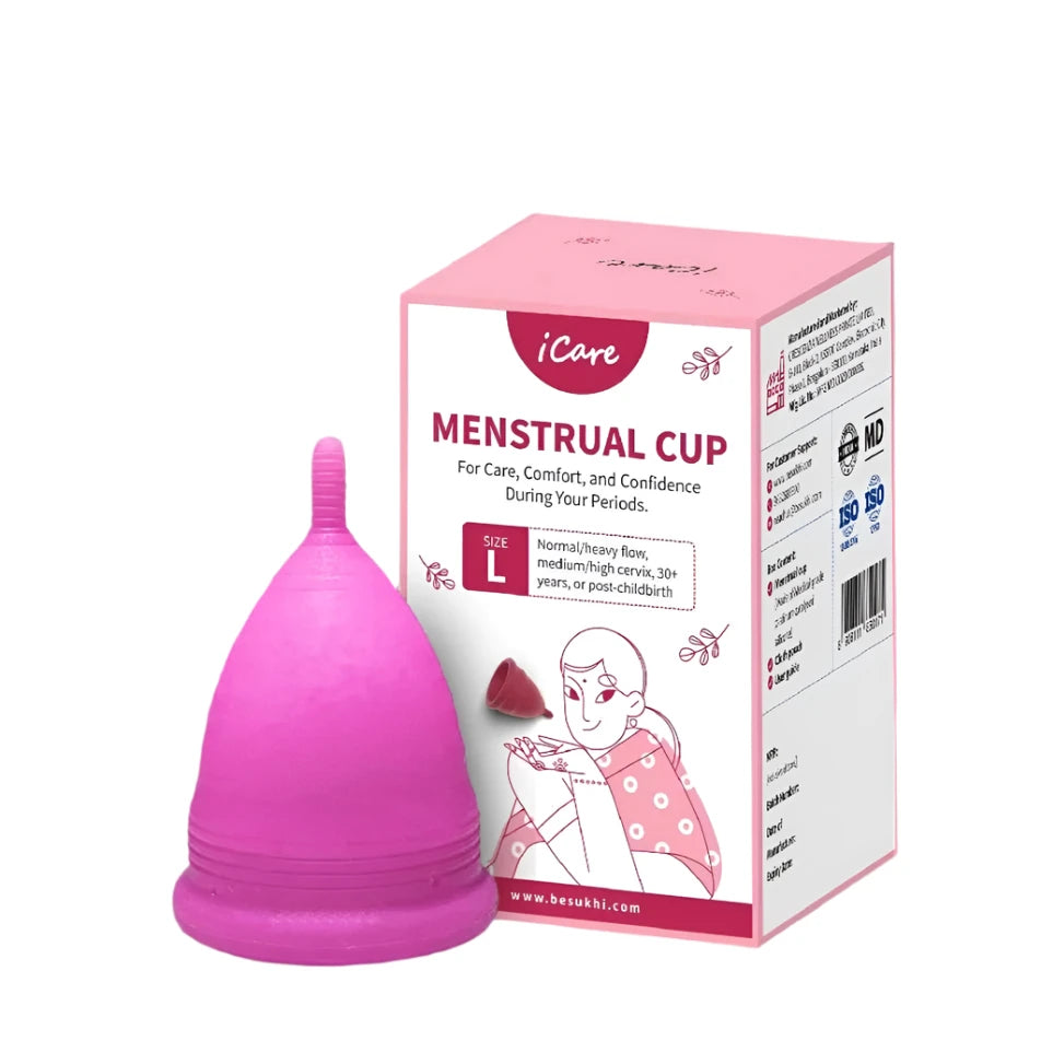 Pink menstrual cup with packaging on a white background